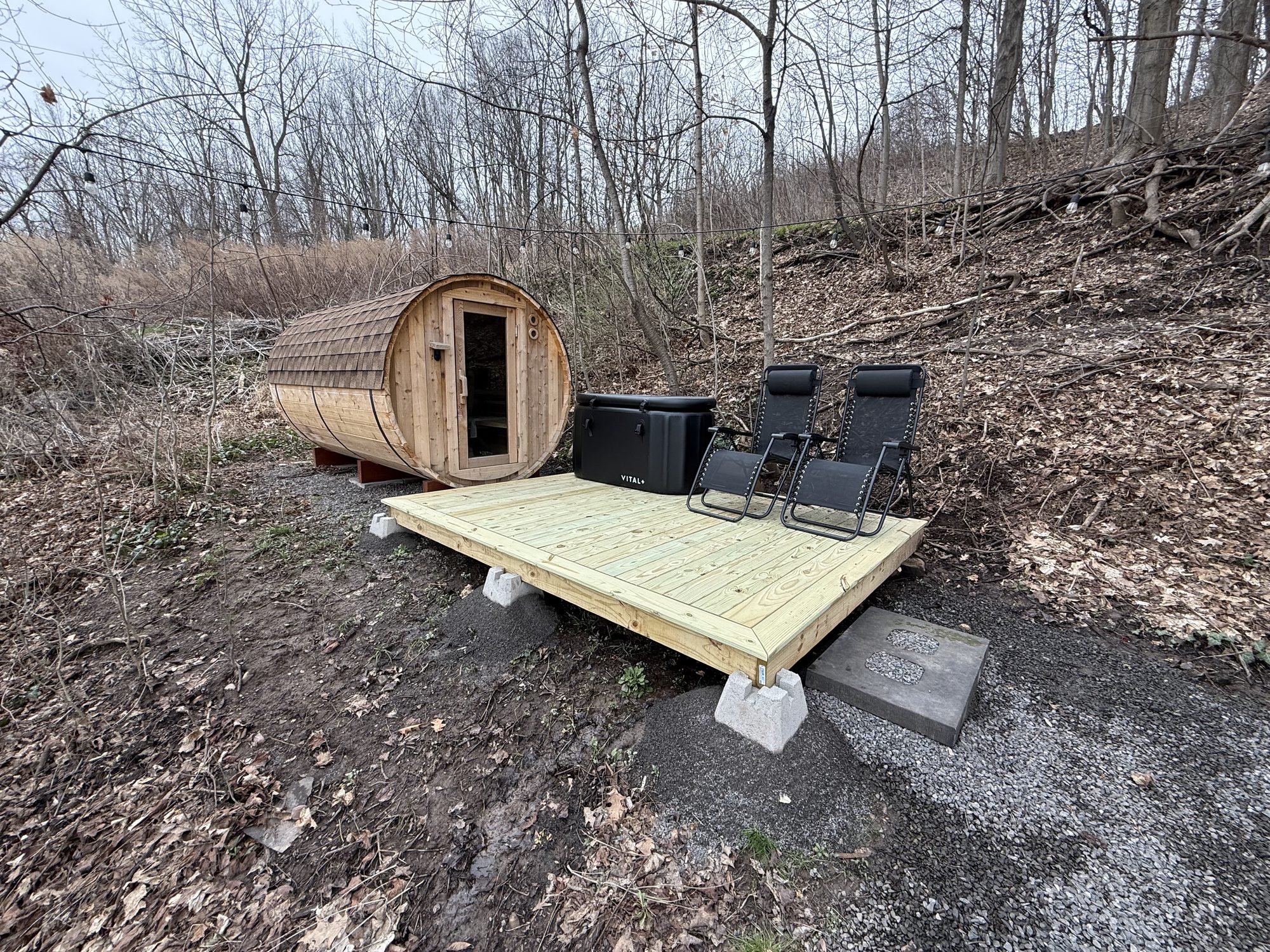 Cedar barrel sauna exterior with cold plunge